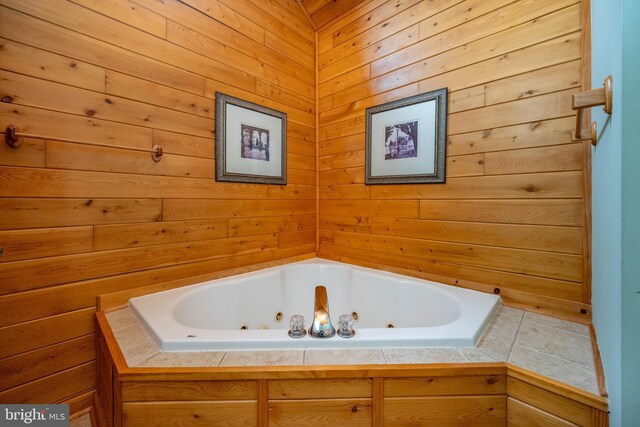 bathroom with a bath and wooden walls