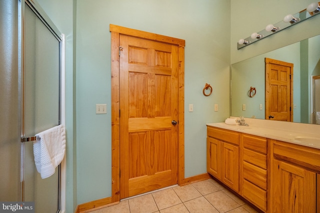 bathroom with vanity, tile patterned floors, and a shower with door