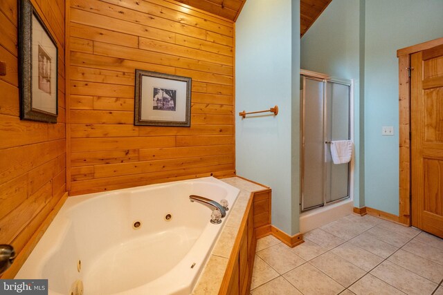 bathroom featuring wood walls, tile patterned flooring, plus walk in shower, and lofted ceiling