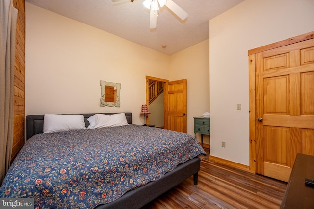 bedroom featuring a textured ceiling, ceiling fan, vaulted ceiling, and hardwood / wood-style flooring