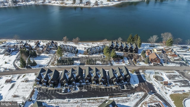 snowy aerial view with a water view