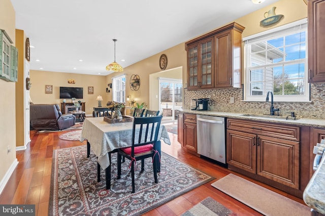 kitchen featuring dishwasher, dark hardwood / wood-style floors, sink, and a wealth of natural light