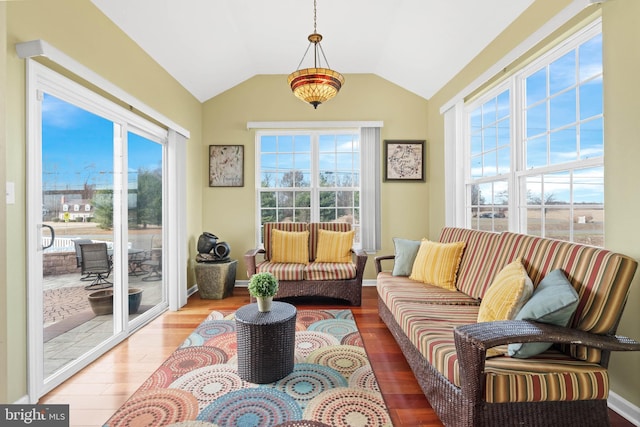 sunroom / solarium featuring vaulted ceiling and plenty of natural light