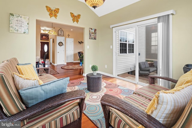 living room with hardwood / wood-style floors and vaulted ceiling