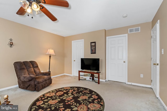 living area with carpet flooring and ceiling fan