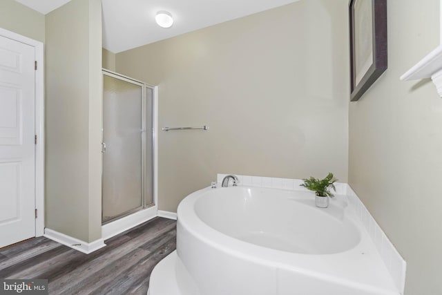 bathroom featuring shower with separate bathtub and hardwood / wood-style flooring