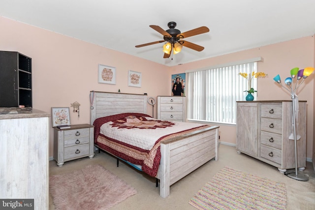 bedroom with ceiling fan and light carpet