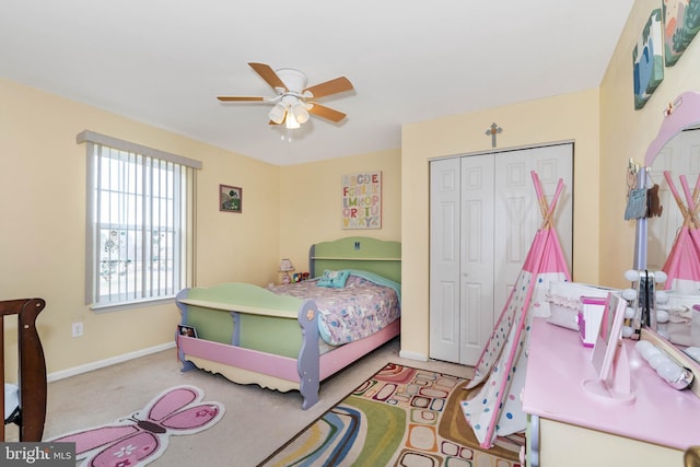 carpeted bedroom featuring a closet and ceiling fan