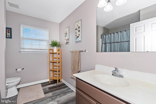 bathroom with hardwood / wood-style flooring, vanity, toilet, and a shower with shower curtain