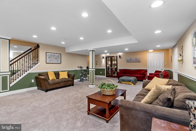 carpeted living room featuring french doors and ornate columns