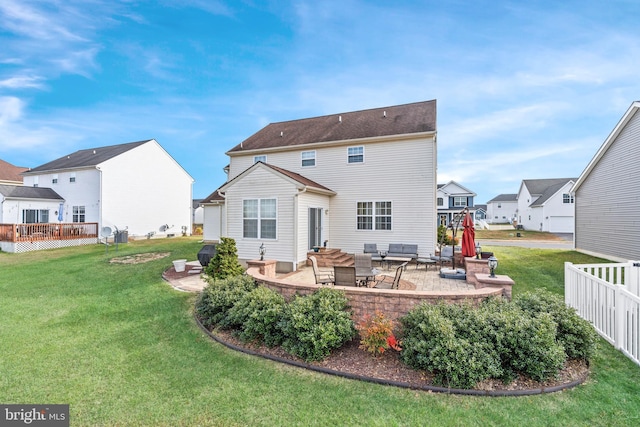 rear view of house featuring a lawn and a patio