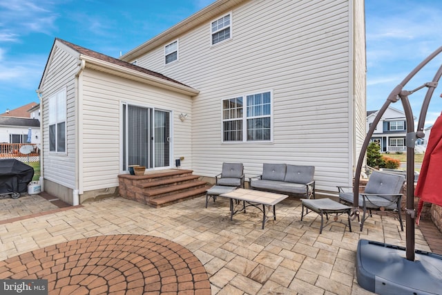 back of property featuring outdoor lounge area and a patio