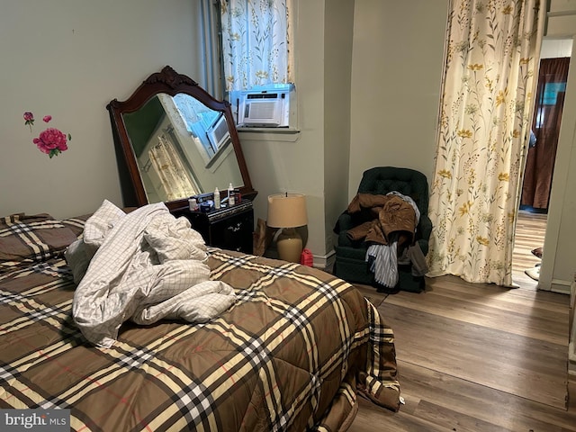 bedroom featuring wood-type flooring and cooling unit