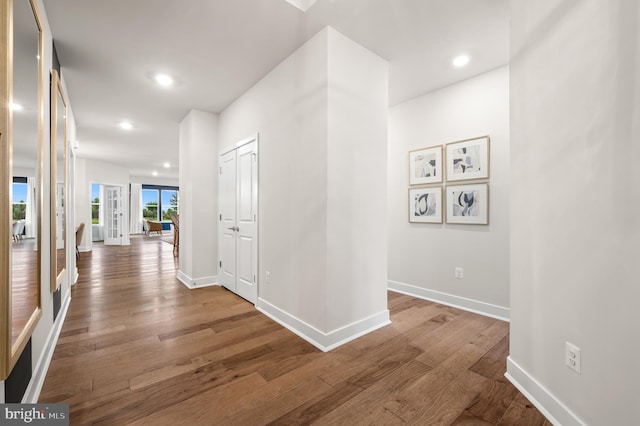 hall with hardwood / wood-style flooring and french doors