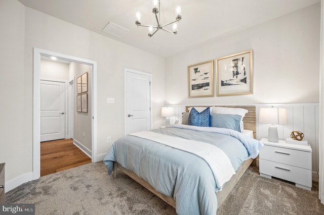 bedroom featuring a chandelier and hardwood / wood-style floors