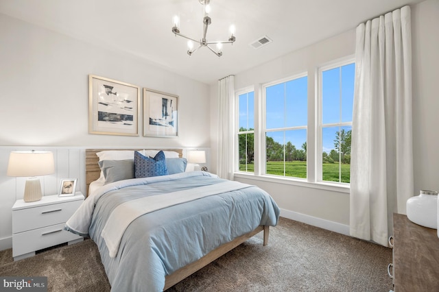 bedroom with a chandelier and carpet floors