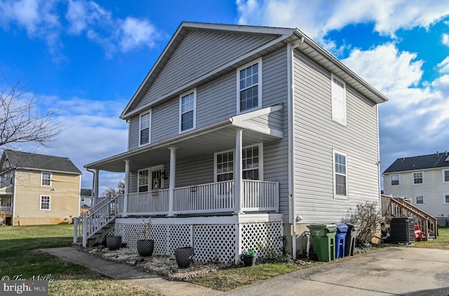 view of front of home with a porch and central air condition unit