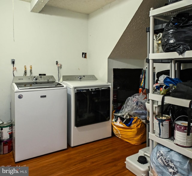 laundry room with wood-type flooring and separate washer and dryer