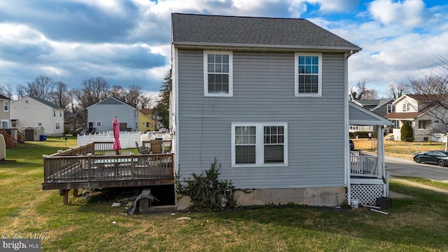 back of house with a lawn, central AC, and a deck