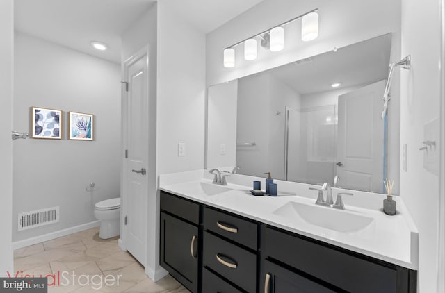 bathroom featuring vanity, toilet, and a shower