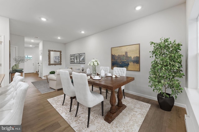 dining space with dark hardwood / wood-style flooring