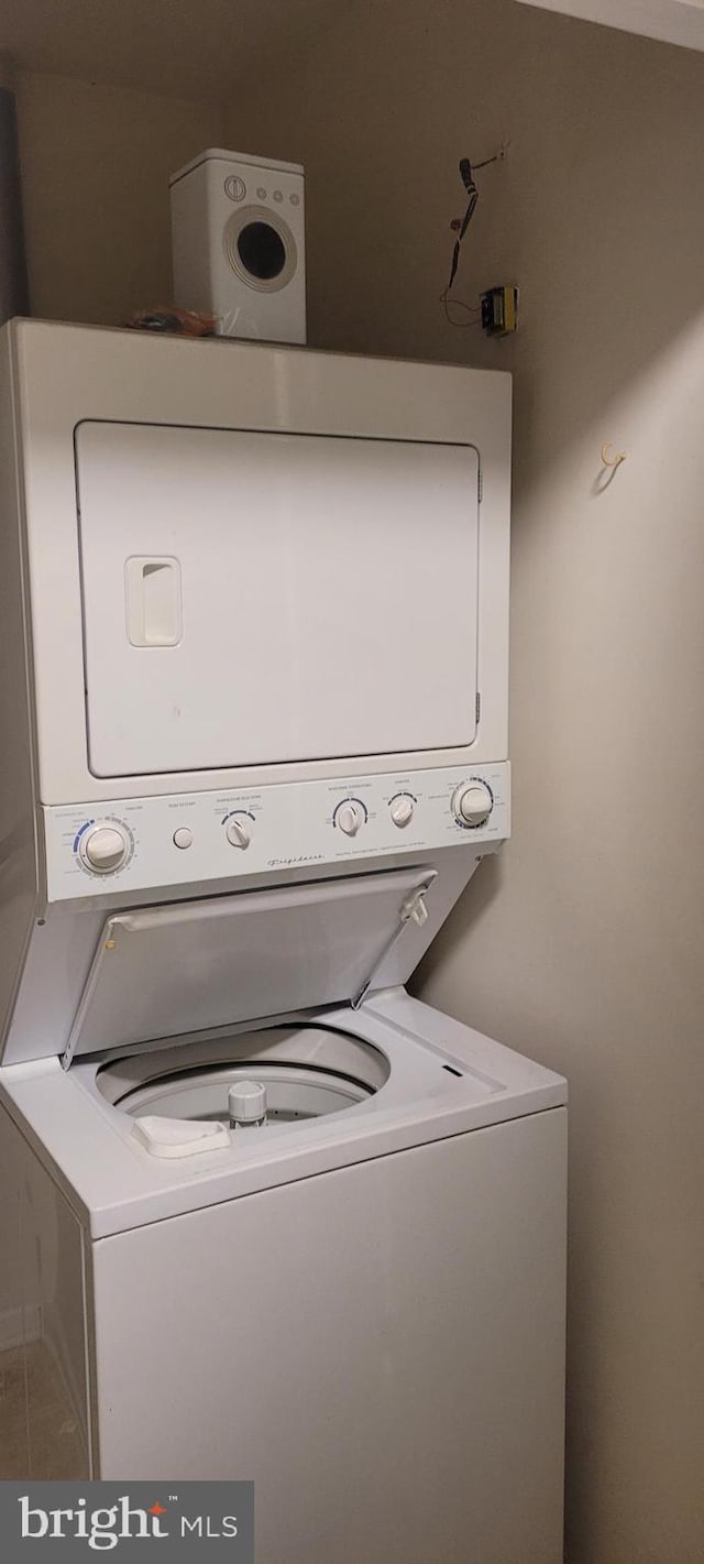 washroom with stacked washer and dryer