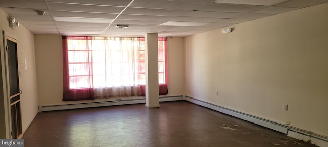 unfurnished room featuring a paneled ceiling and a baseboard radiator