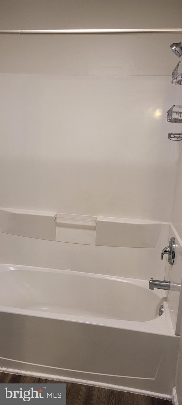 bathroom featuring bathing tub / shower combination and wood-type flooring