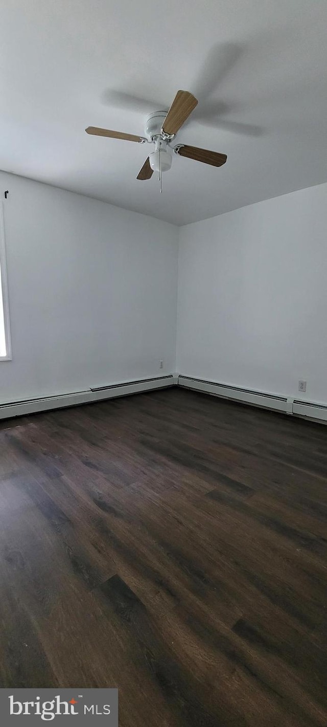 unfurnished room featuring dark wood-type flooring