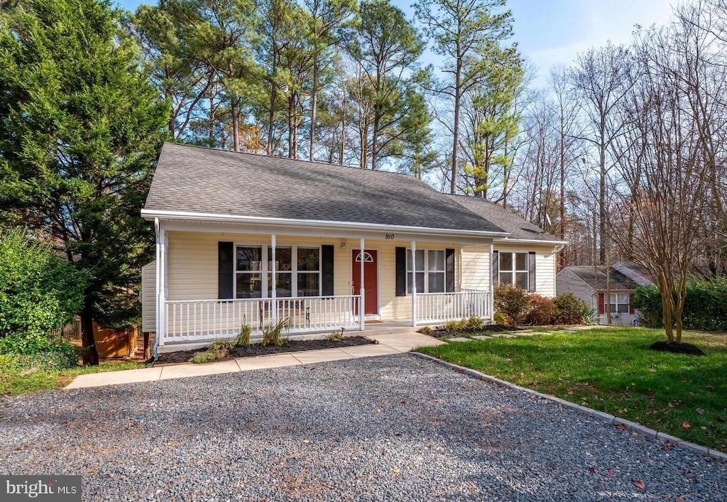 ranch-style house with a porch and a front lawn