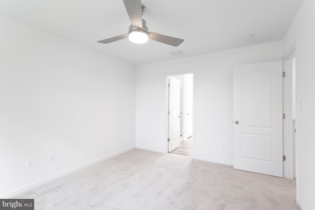 carpeted spare room with ceiling fan