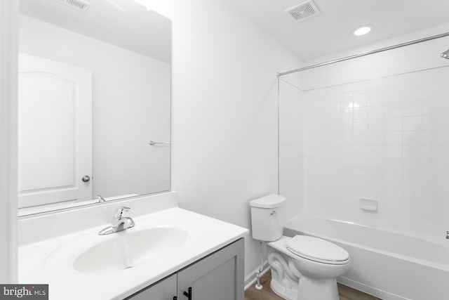 full bathroom featuring hardwood / wood-style floors, vanity,  shower combination, and toilet