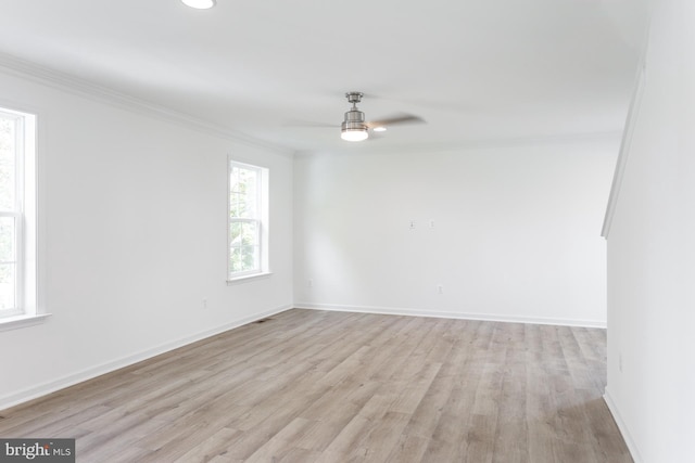 spare room with crown molding, ceiling fan, and light hardwood / wood-style floors