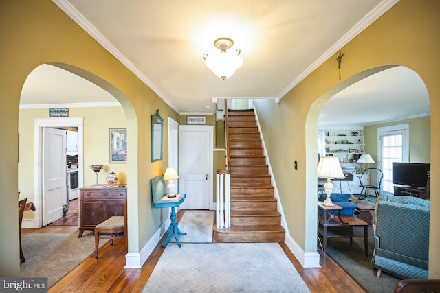 staircase with hardwood / wood-style floors and crown molding