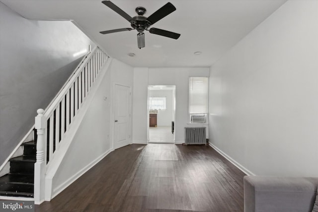 interior space with radiator, ceiling fan, cooling unit, and dark hardwood / wood-style floors