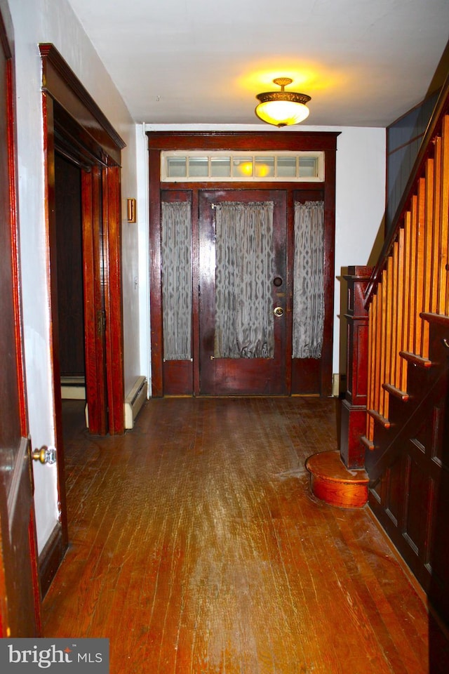 entrance foyer with dark hardwood / wood-style flooring and a baseboard radiator