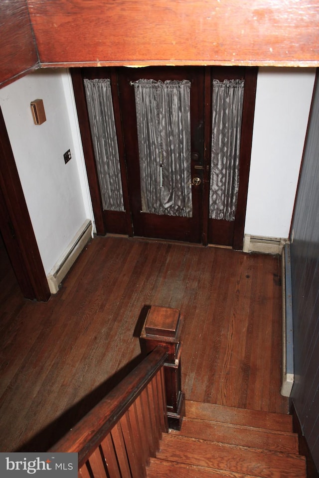 foyer featuring dark hardwood / wood-style flooring and a baseboard heating unit