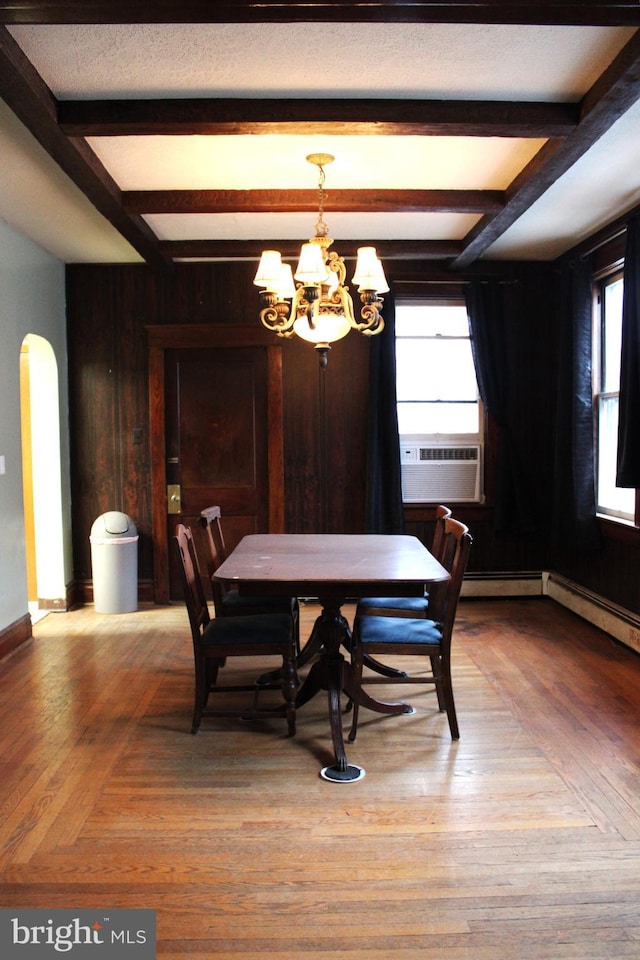 dining room featuring hardwood / wood-style floors, an inviting chandelier, and a wealth of natural light