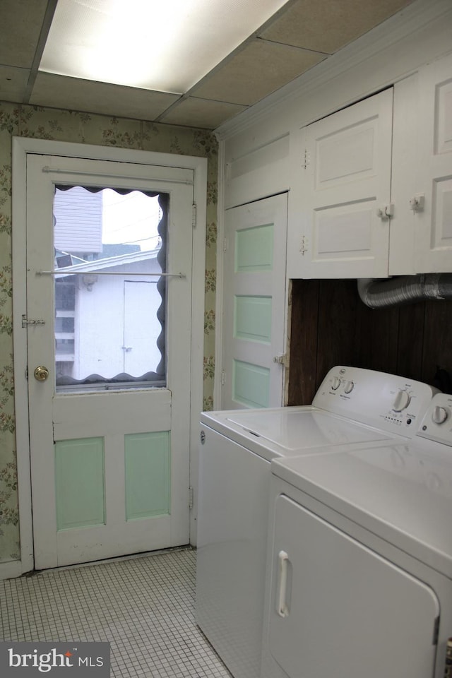 laundry room featuring washer and dryer and light tile patterned flooring