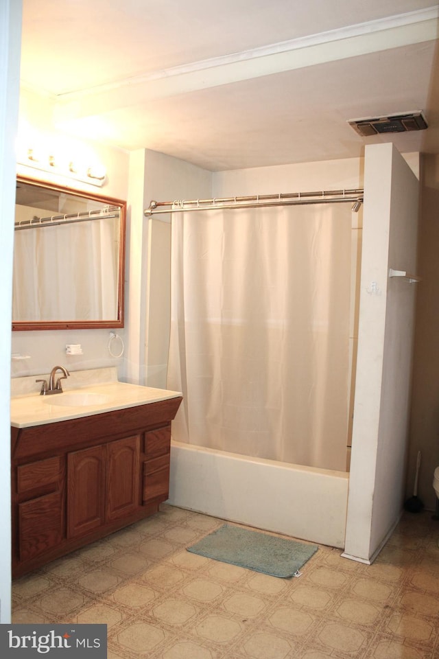 bathroom featuring vanity and shower / bathtub combination with curtain