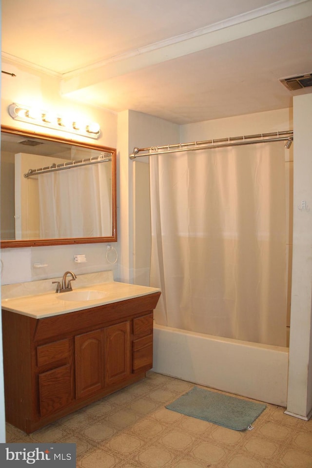 bathroom featuring shower / bath combo with shower curtain and vanity