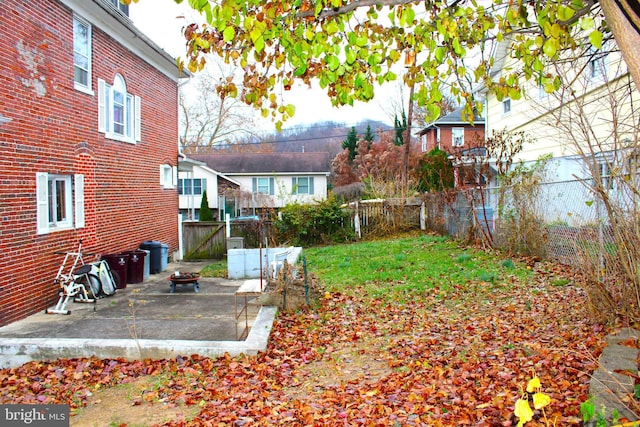 view of yard with a patio and an outdoor fire pit