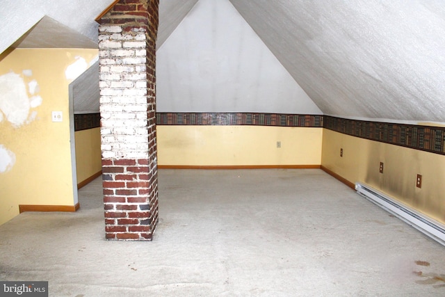 bonus room with decorative columns, vaulted ceiling, baseboard heating, and light colored carpet