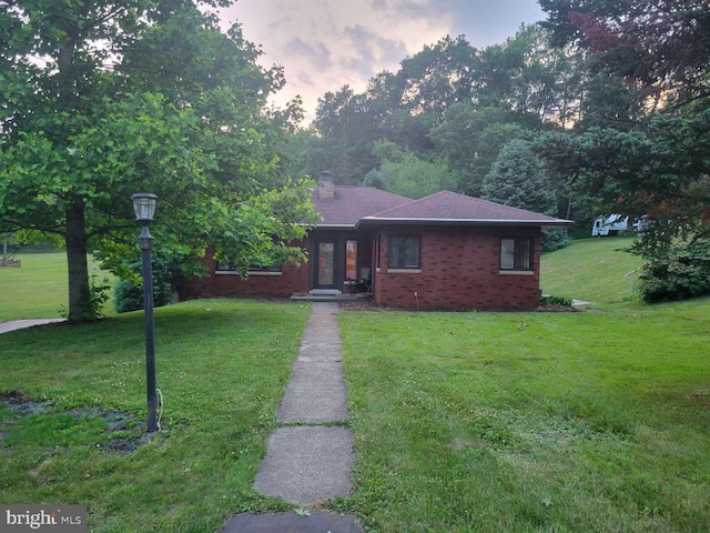 view of front of house with a yard