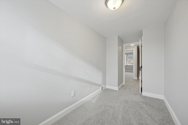 hall featuring light colored carpet