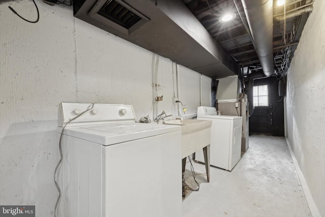 clothes washing area featuring washer and clothes dryer