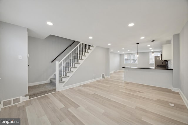 unfurnished living room featuring light wood-type flooring