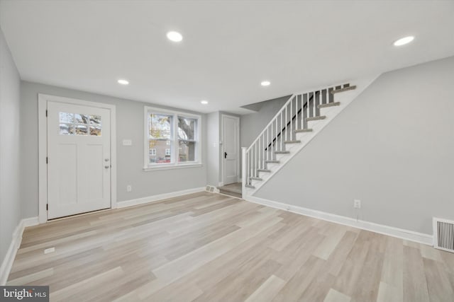 foyer entrance with light hardwood / wood-style floors