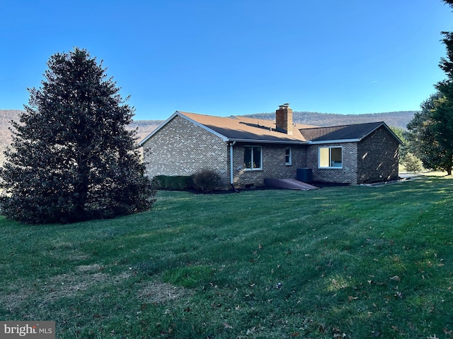 rear view of house with a yard