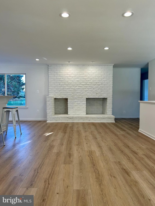 living room with wood-type flooring and a fireplace